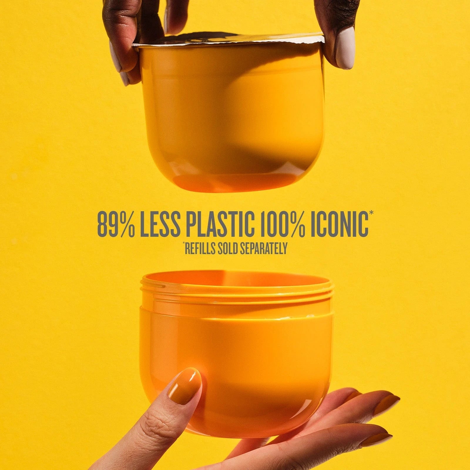 This image is a yellow background with two hands holding one end of the Sol de Janeiro Brazilian Bum Bum Cream refill pod and the refill insert. The text on the image reads as follows "89% less plastic 100% iconic refills sold separately." in grey text
